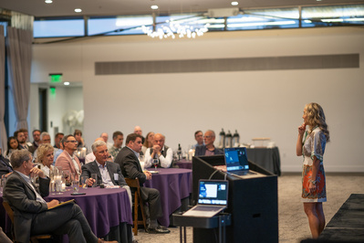 Laurie Baedke speaking to a crowd of medical professionals