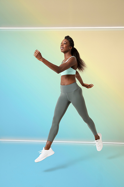 Pilates instructor Marcia M. jumping in the air.