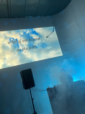 A still of a video projection at a DIY party that reads 