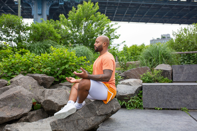 Walter Kemp, meditating outside in the seated position.