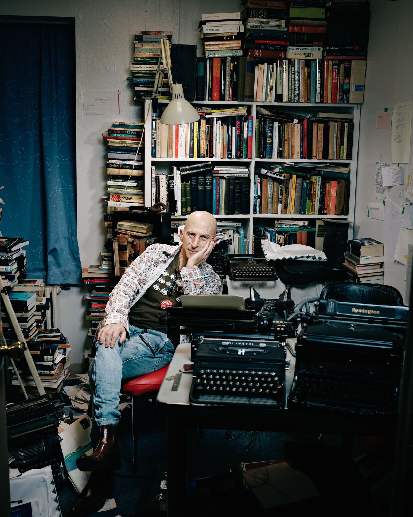 Writer and journalist Robert Neuwirth sitting in his clustered office in midtown Mahanttan NY