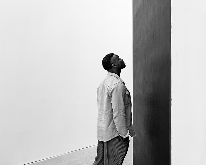 Adam Pendleton surveying the installation of his 'An Abstraction' at Pace Gallery. New York, NY.