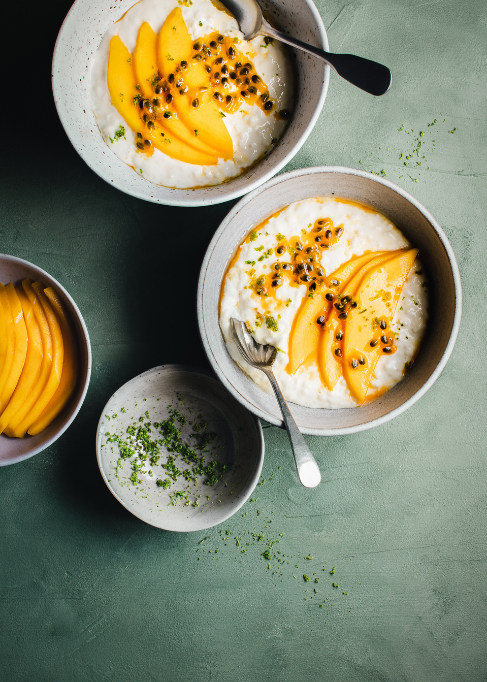 Elise Humphrey - food photographer - bowls of mango passion fruit and lime rice pudding on a painted green backdrop