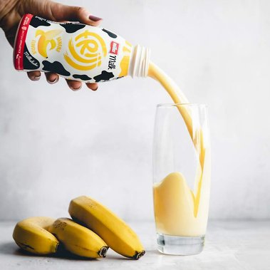 Elise Humphrey - food photographer - muller banana frijj milkshake pouring into a glass