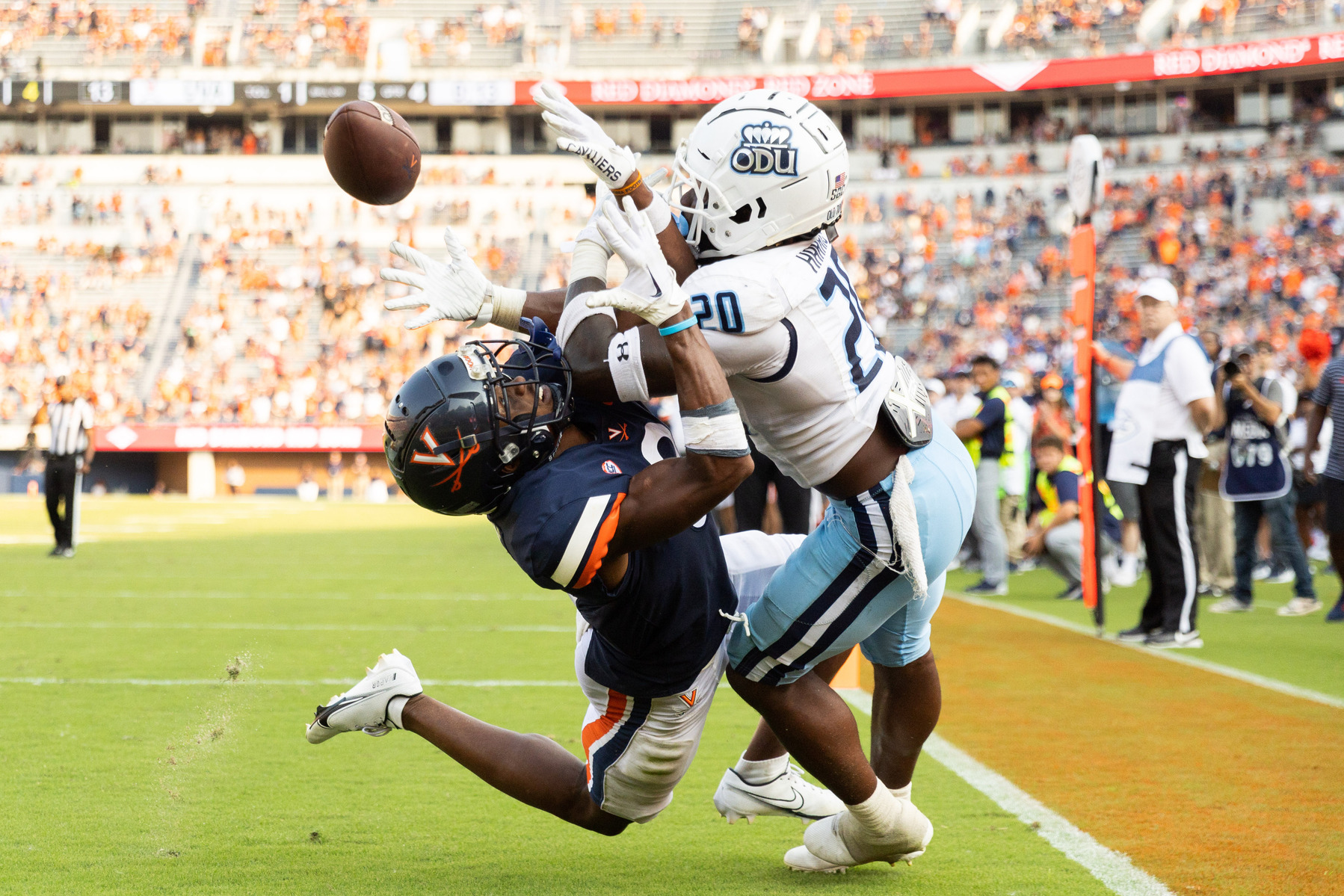 Virginia's Dontayvion Wicks, left, and Old Dominion's Tobias Harris, right, fight for the ball during a football game in Charlottesville, Va on Saturday, Sept. 17, 2022.