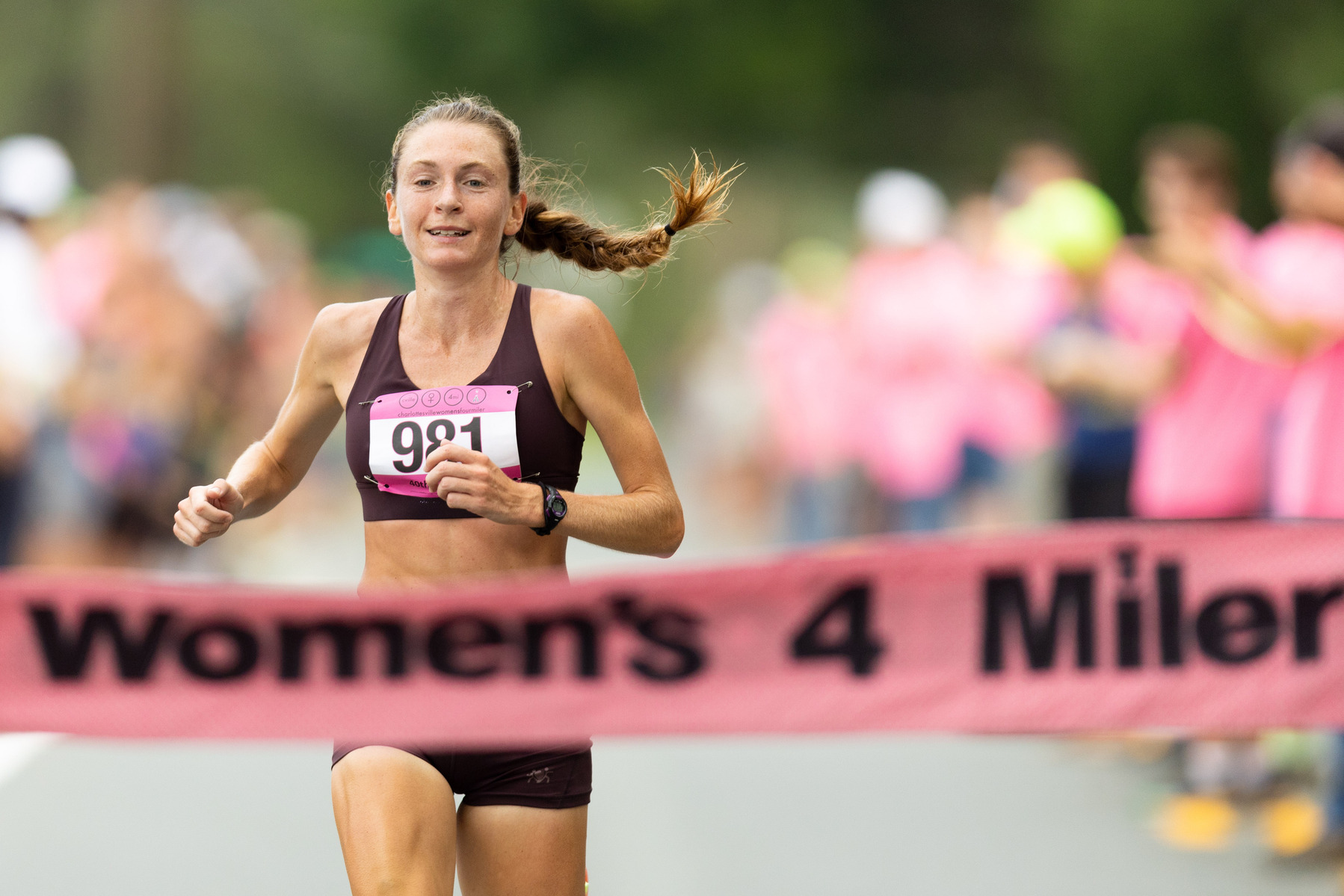 Cleo Boyd crosses the finish line in first place in the Charlottesville Women's Four Miler at Foxfield in Charlottesville, Va., on Saturday, Sept. 3, 2022.