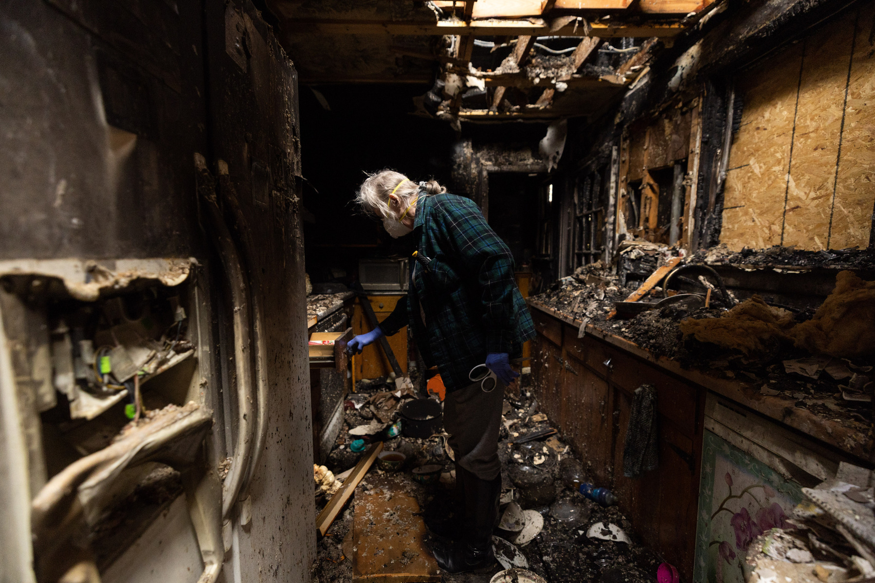 Alene Lawson opens a drawer in the kitchen of her house which on caught fire the day before in Charlottesville, Va., on Wednesday, March 22, 2023.