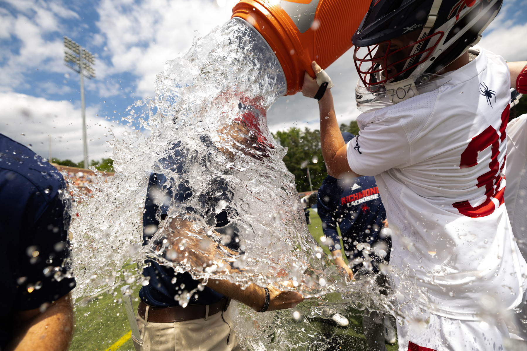 Richmond head coach Dan Chemotti gets a water bath from goalie Devin Craven after winning the Atlantic 10 Conference championship game against High Point University, on Monday, May 6, 2024.