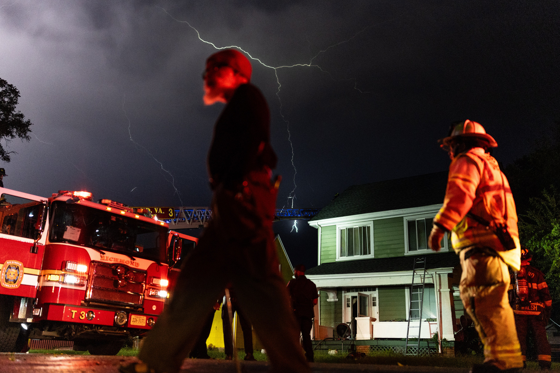 Emergency responders fight a fire after lightning struck the house of Ola Slaughter in Richmond, Va., on Thursday, Sept. 7, 2023.