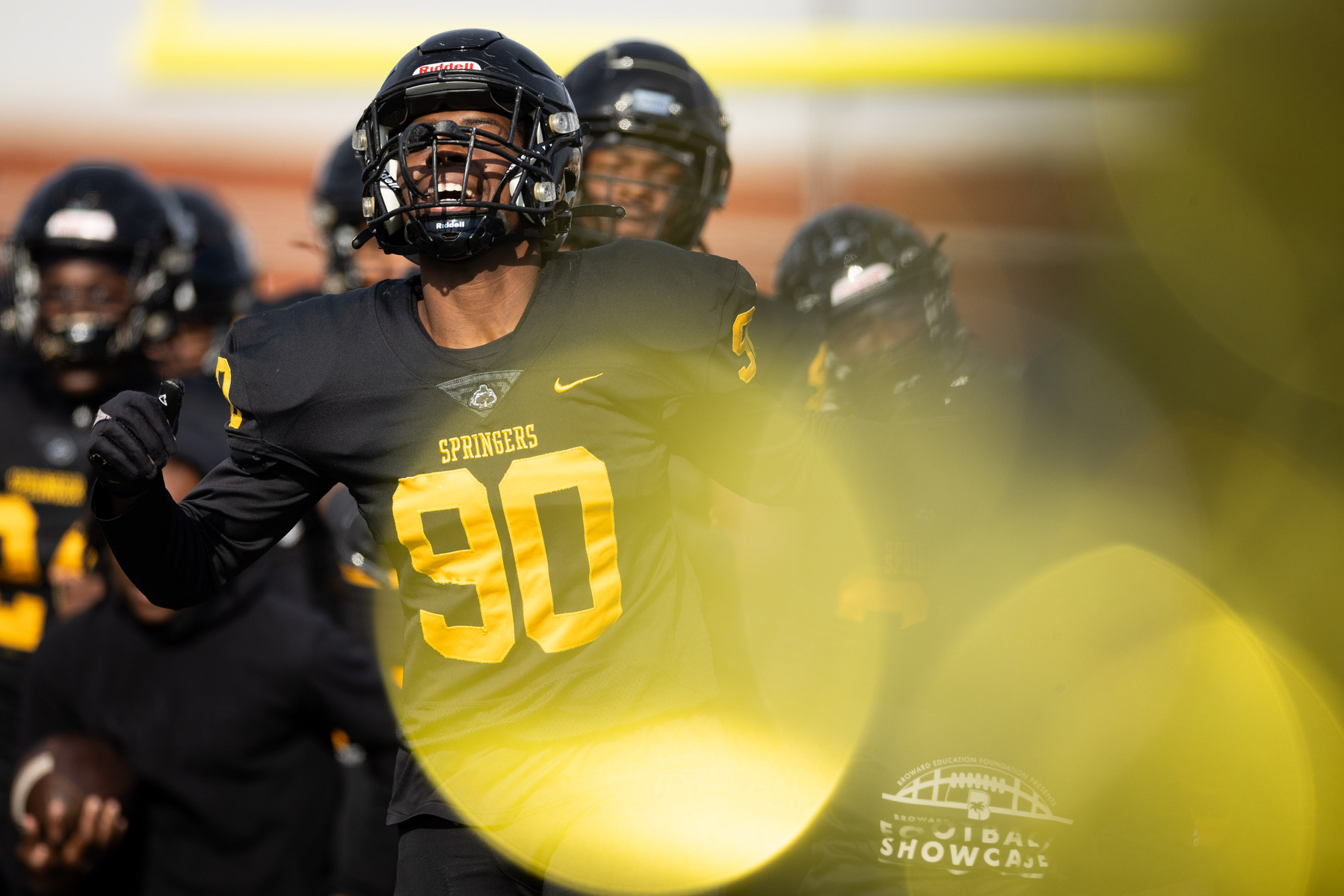 Highland Springs High School defensive end Miaun Morris runs out with his team before a football game against Manchester High School in Highland Springs, Va., on Friday, Nov. 24, 2023.
