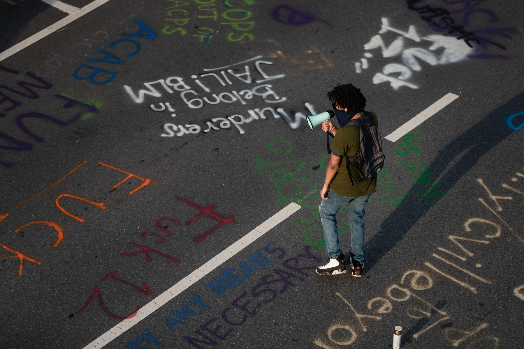 A local activist leads a chant during a Black Lives Matter demonstration in Charlottesville, Va., Sunday, June 21, 2020.