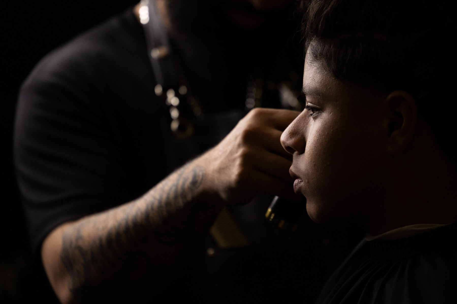 Mustafa, a seventh grader at Buford Middle School, has his hair cut in Charlottesville Va., Monday, Feb. 13, 2023. Local barbers and hair braiders give free hair cuts and braids to students and staff thanks to a collaboration between Charlottesville Schoo