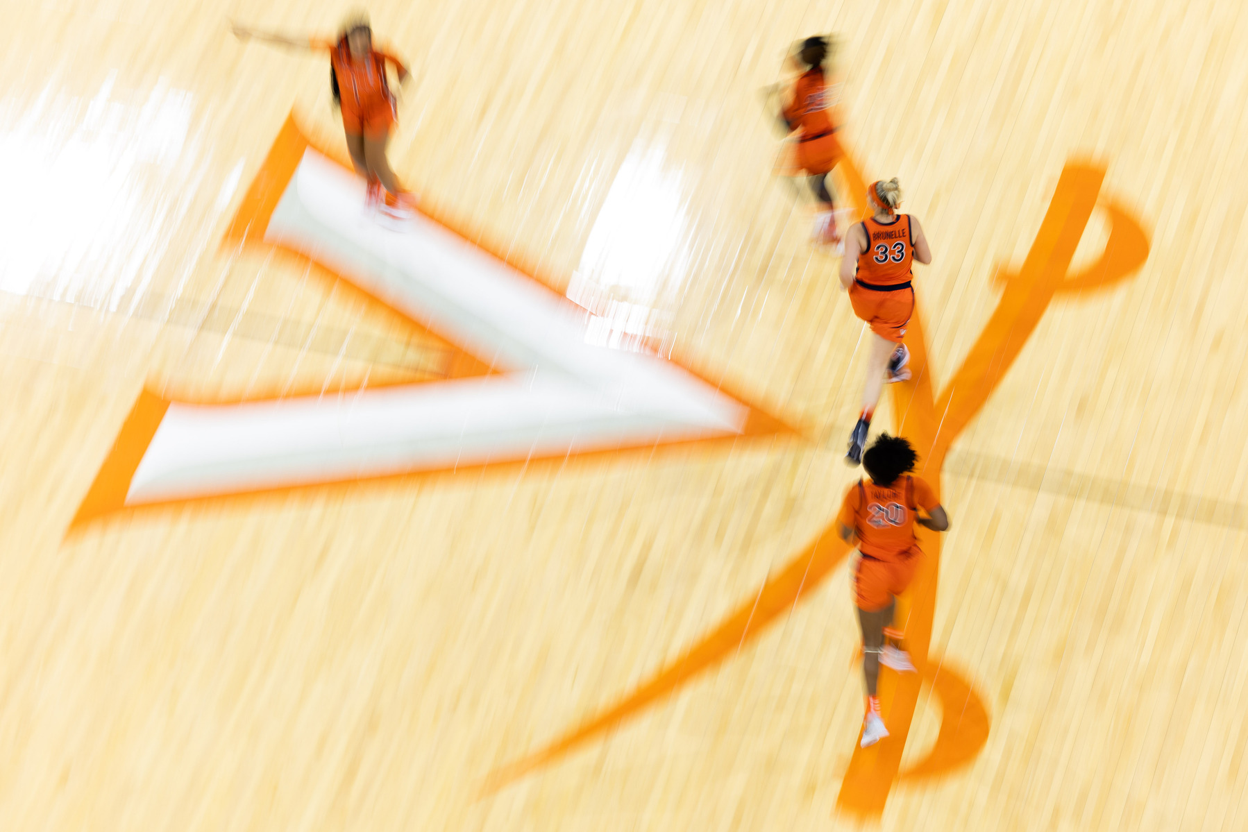 Virginia women's basketball players run across center court during a game against Georgia Tech at John Paul Jones Arena in Charlottesville, Va., Thursday, Dec. 29, 2022.