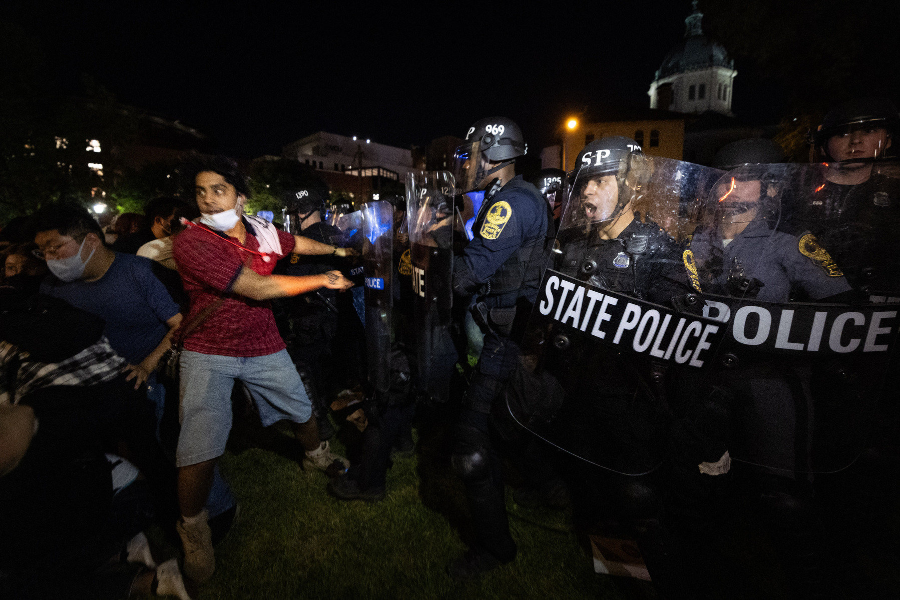 Pro-Palestinian demonstrators and Virginia State Police officers clash in front of James Branch Cabell Library on VCU’s campus in Richmond, Va., Monday, April 29, 2024.