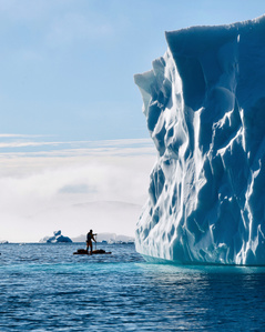 SUP paddling very close of iceberg in Greenland – Stand up paddling expedition.