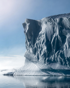 Iceberg wall lit by the midnight sun in Greenland – Stand up paddling adventure.
