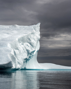 Iceberg structure under a dramatic sky in Greenland – Stand up paddling adventure.