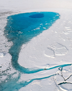 Blue meltwater lake from above on Greenlands ice sheet – Stand up paddling expedition.