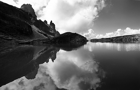 Reflection in a mountain lake in black and white.