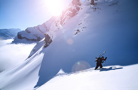 Adventure photographer Switzerland – freeride session in the  swiss alps – going for the top.