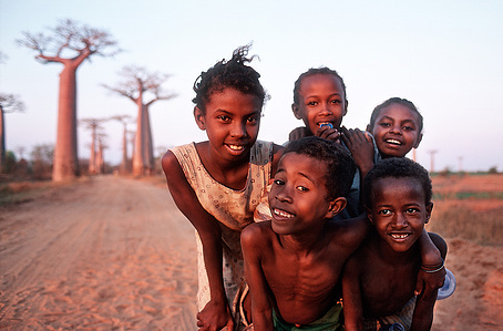 Kids having fun and posing in front of the camera. Avenue of the baobabs on Madagascar&amp;#x27;s west coast.