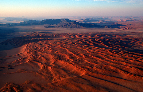 Deep red sand dune landscape from above.