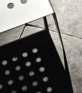 Interior detail of chair creating a shadow on the stone floor.