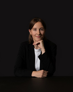 Employee low key business portrait with dark neutral background photographed  in Zurich.