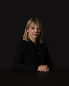Employee low key business portrait with dark neutral background photographed  in Zurich.