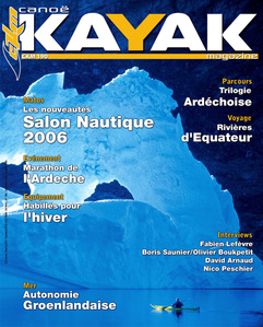 Publication tearsheet of a magazine cover showing a kayaker paddling in front of a huge iceberg with two arches early morning in Greenland.