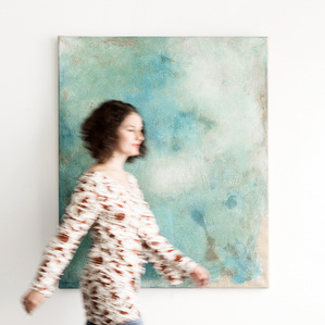 Editorial photography – artist passing by her painting in art gallery in Zurich, Switzerland – Photographer Jean-Luc Grossmann.