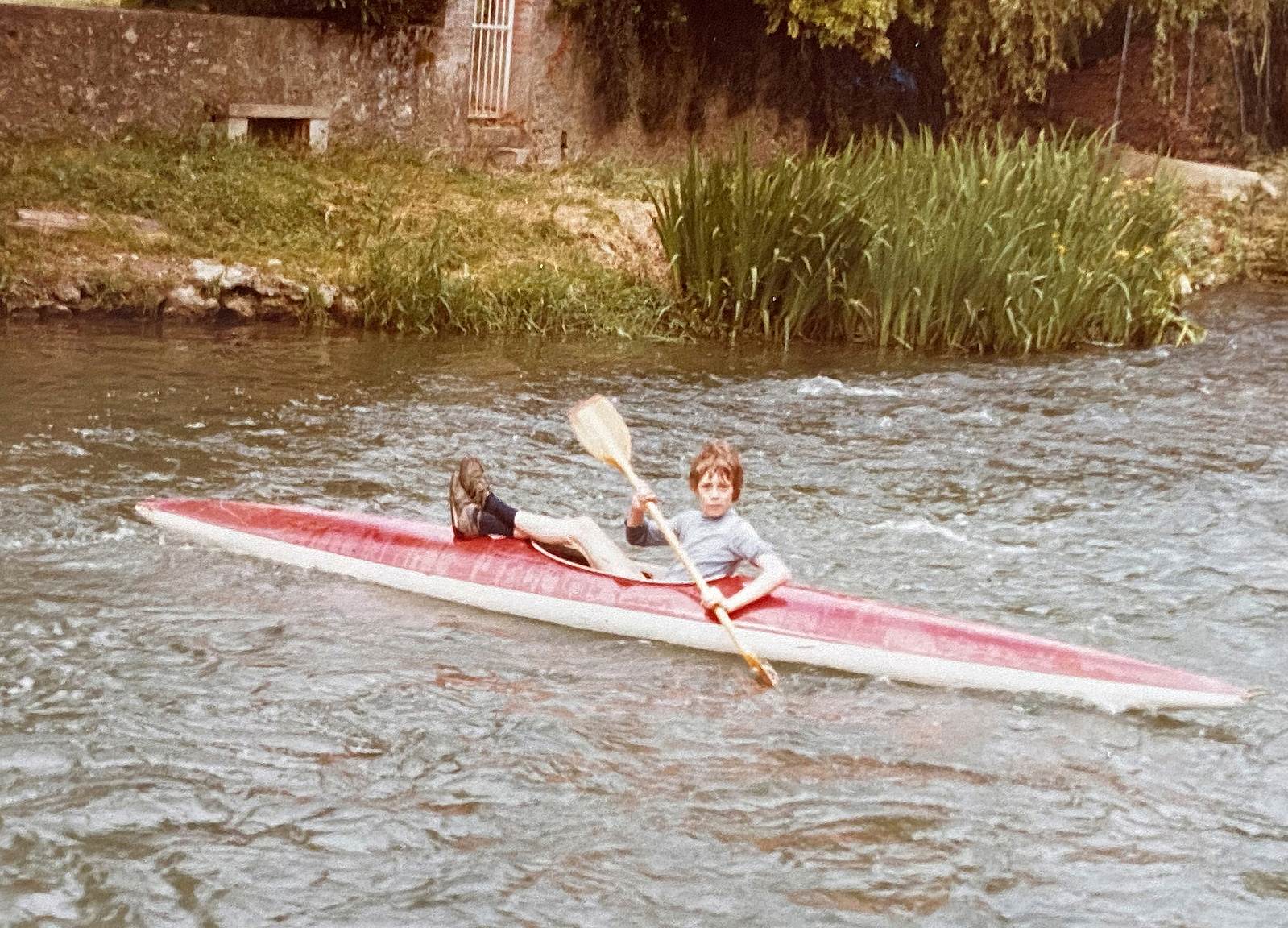 Jean-Luc Grossmann kayaking a river at his young age.
