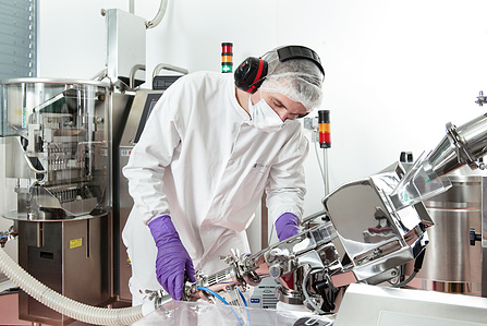 Industrial photograph of worker operating machine.
