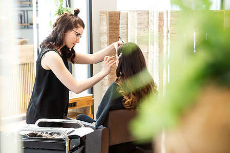 Hairdresser at work in his hair salon.