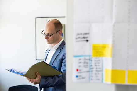 Person looking at documents in his office in Zurich