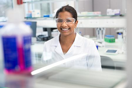 Pharma portrait of employee standing in the lab in Zurich.
