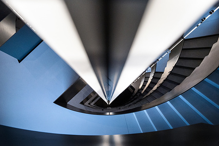 Interior photography of stairway with dynamic perspective.