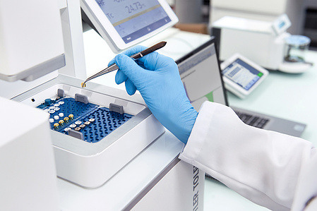 Pharma photography detail of person working in the lab in Zurich.