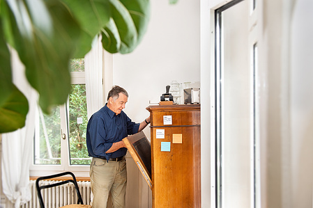 Person opening his desk at home in Zurich, Switzerland.