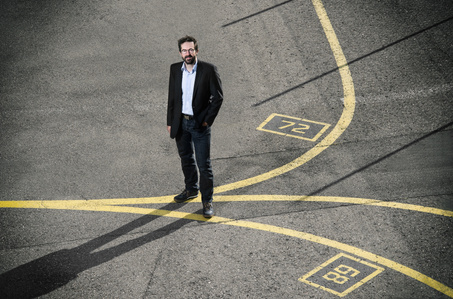 On location photograph of Markus Weber, CTO at Device25 standing on the airporat tarmac photographed by editorial photographer J-L Grossmann living in Zurich, Switzerland.