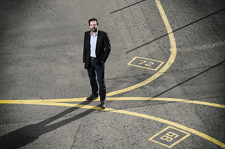 On location photograph of Markus Weber, CTO at Device25 standing on the airporat tarmac photographed by editorial photographer J-L Grossmann living in Zurich, Switzerland.