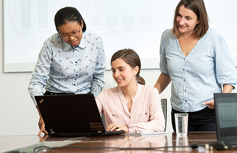 Discussion in meeting room in front of the computer.