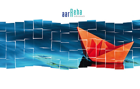 Compositon with red paper boat floating on deep blue water.
