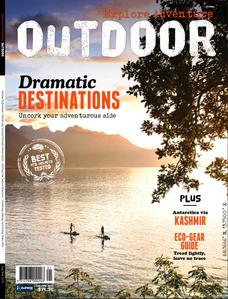 Publication tearsheet of a magazine cover with two tiny stand up paddlers paddling on lake Geneva at sunset in Switzerland.
