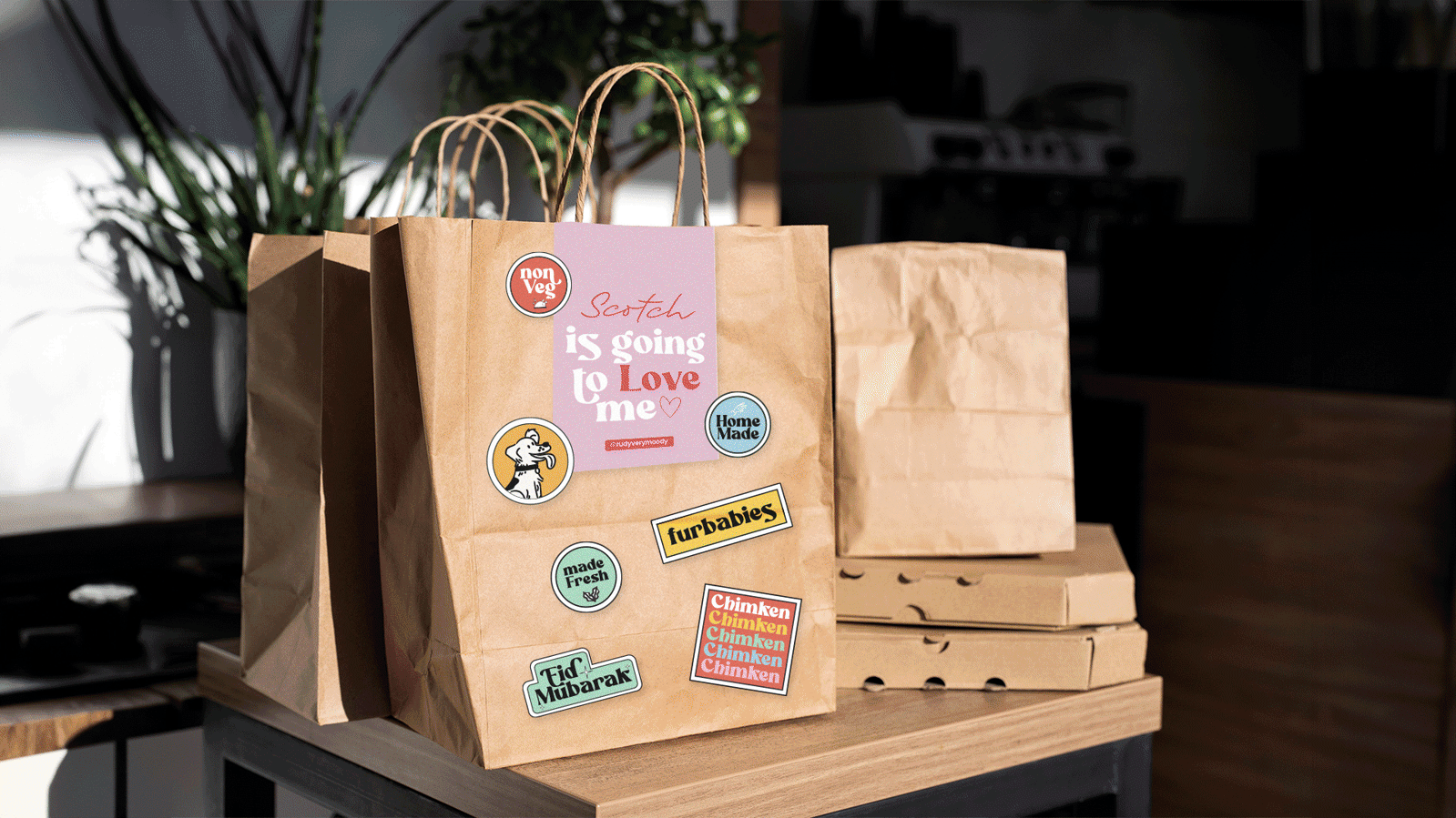 GIF of mockups of branding including packaging, thank you cards and stickers for the brand 'Rudy's Kitchen'