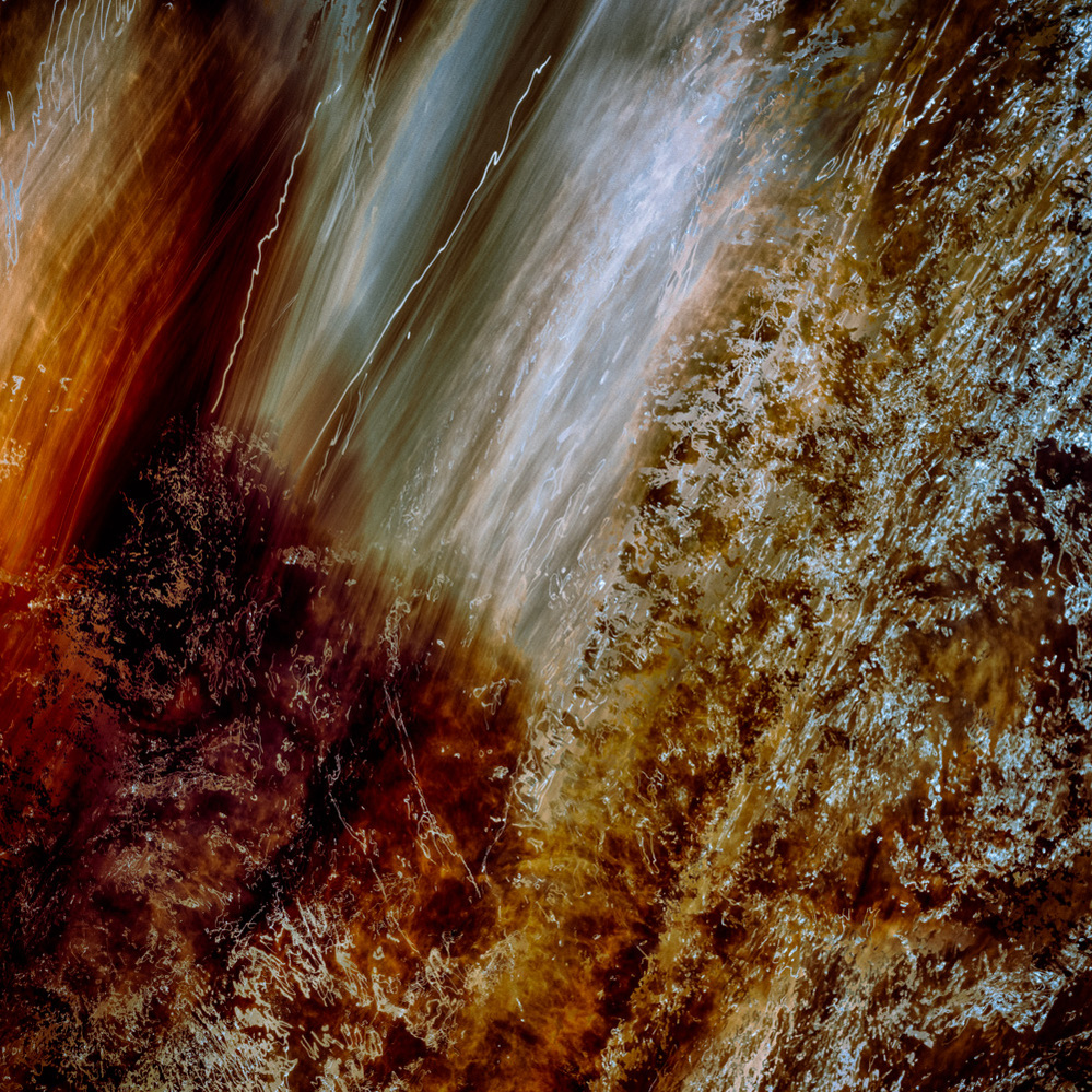 Abstract art of many earth hues with some splashes of white.