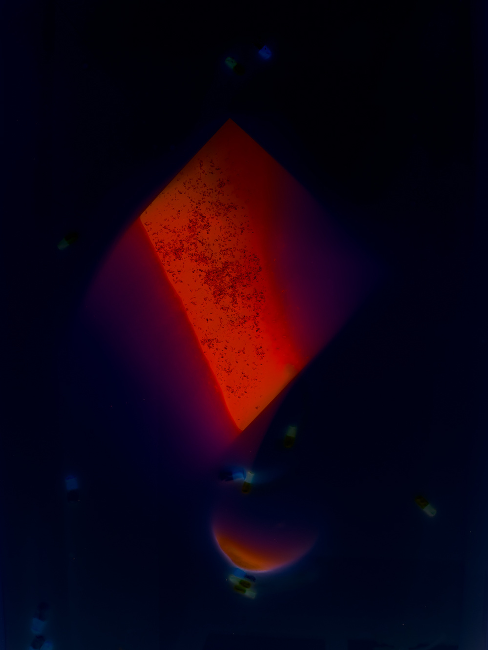 Abstract colour image of a red rectangular pattern against a dark background.