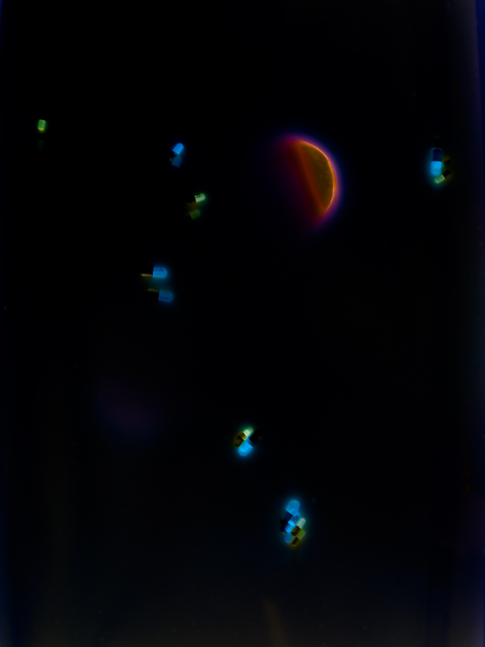 Abstract colour image of orange and pale blue patterns against a dark background.