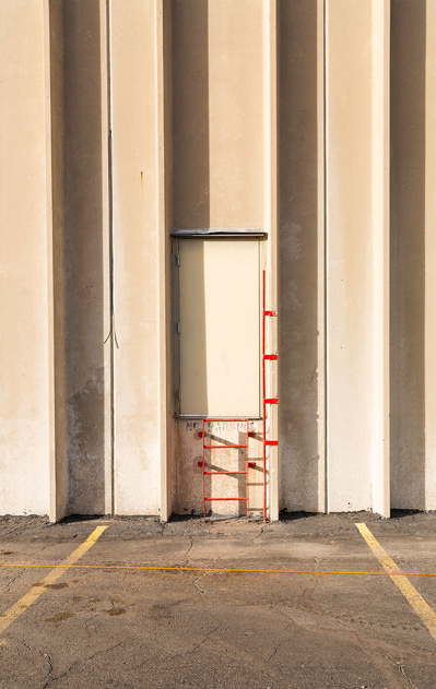 Minimalistic architecture featuring a white door, red ladder and parallel lines.