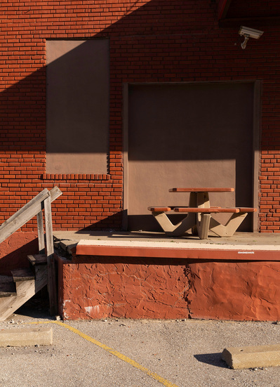 Burnt orange shipping and receiving dock featuring a matching retro picnic table.